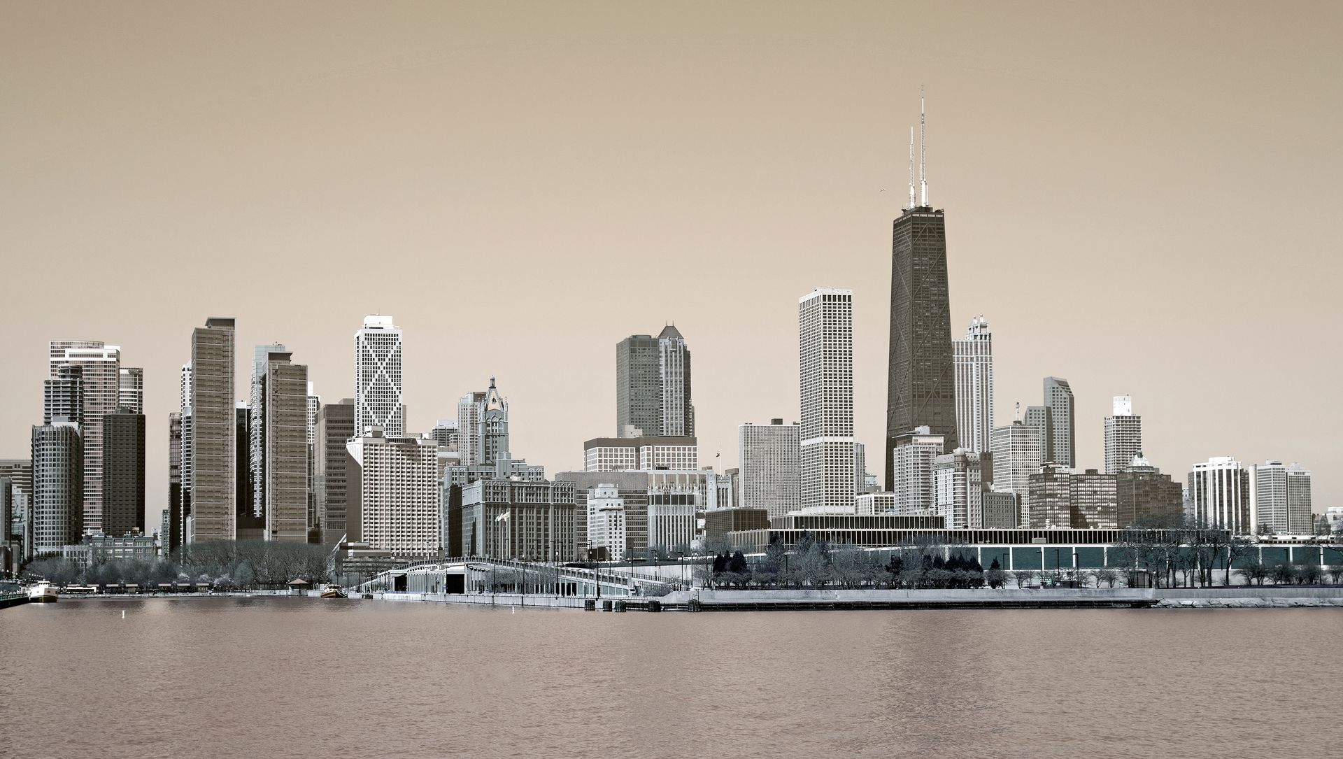 A city skyline with a large body of water in the foreground