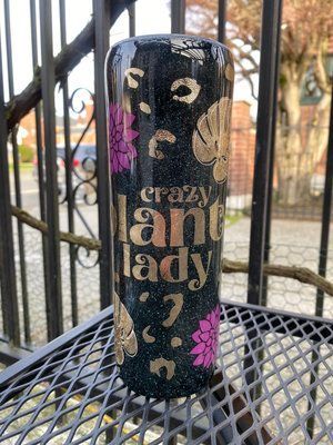 Black tumbler with gold and pink accents,