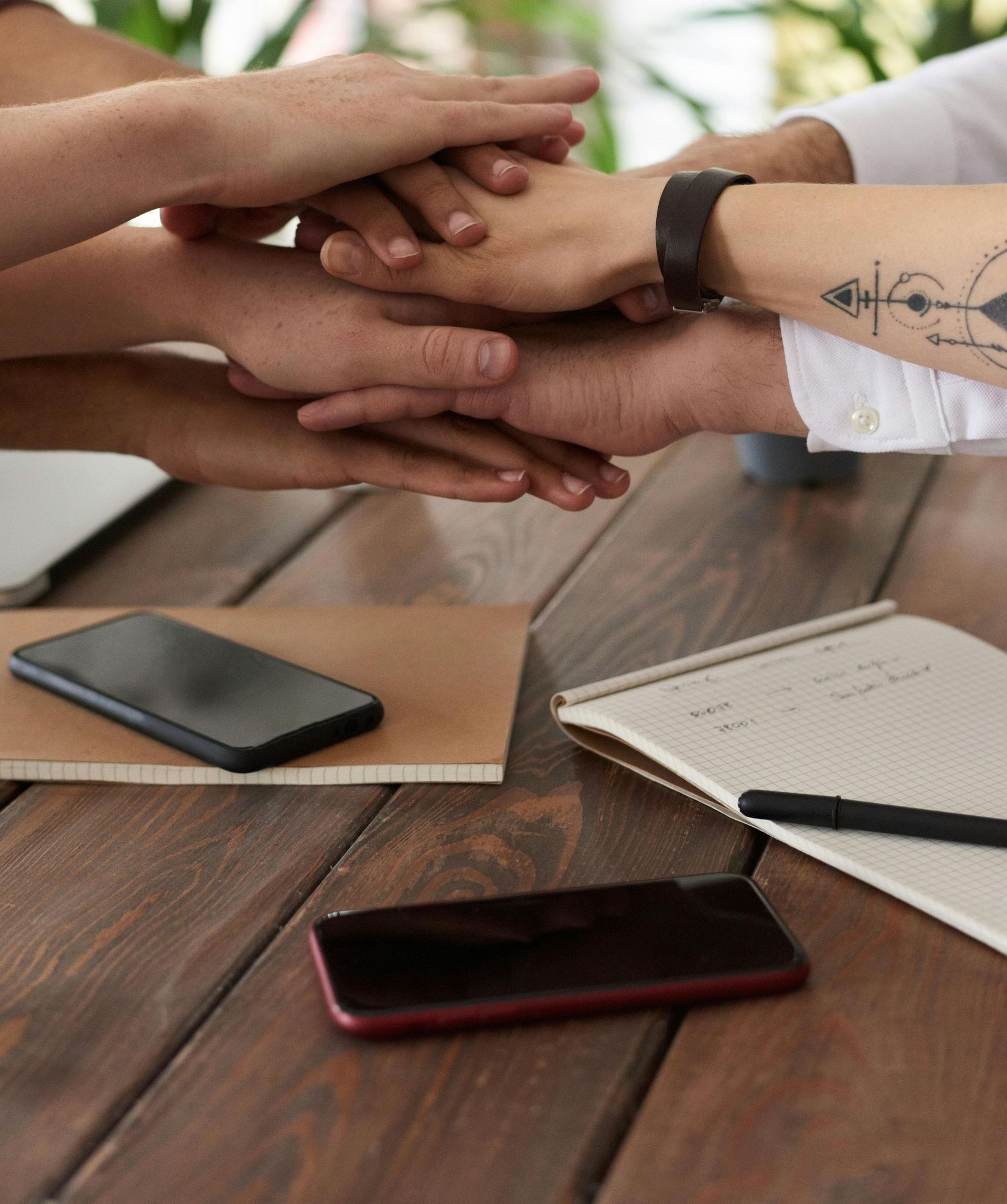 Lakeland SEO, image of team of office workers stacking their hands on top of one another showing power of the team.