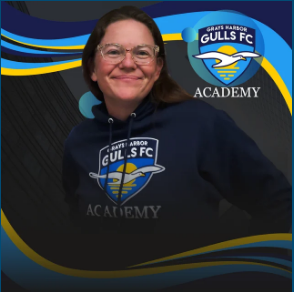 Woman wearing a navy hoodie with Grays Harbor Gulls FC Academy logo, smiling.