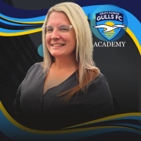 Woman in glasses smiles, Grays Harbor Gulls FC Academy logo in the background.
