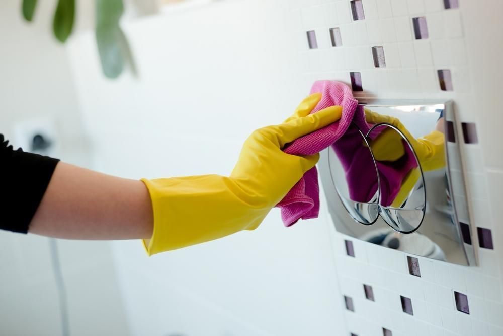 A Person Wearing Yellow Gloves — Professional Cleaning Company in Burrum Heads, QLD