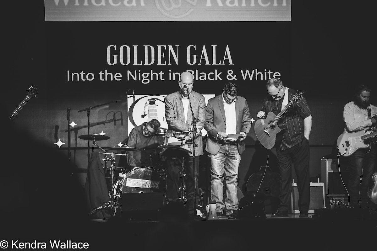 Band performing onstage at a Golden Gala event in black and white.