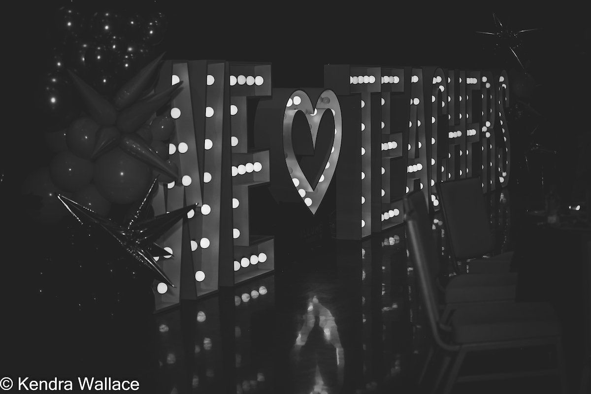 Black and white photo of illuminated letters spelling 