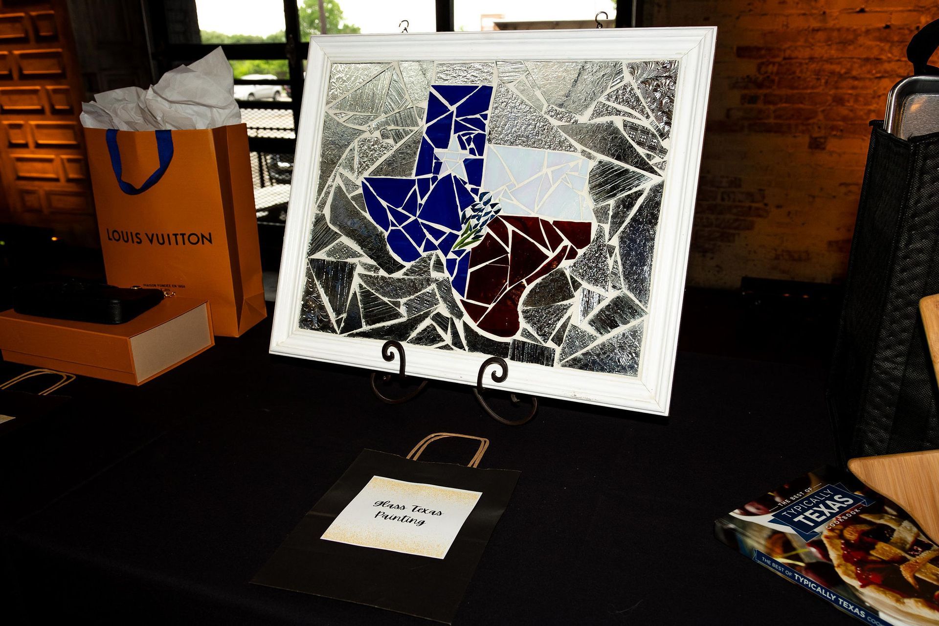 Texas flag mosaic art display with a gift bag and table setting.