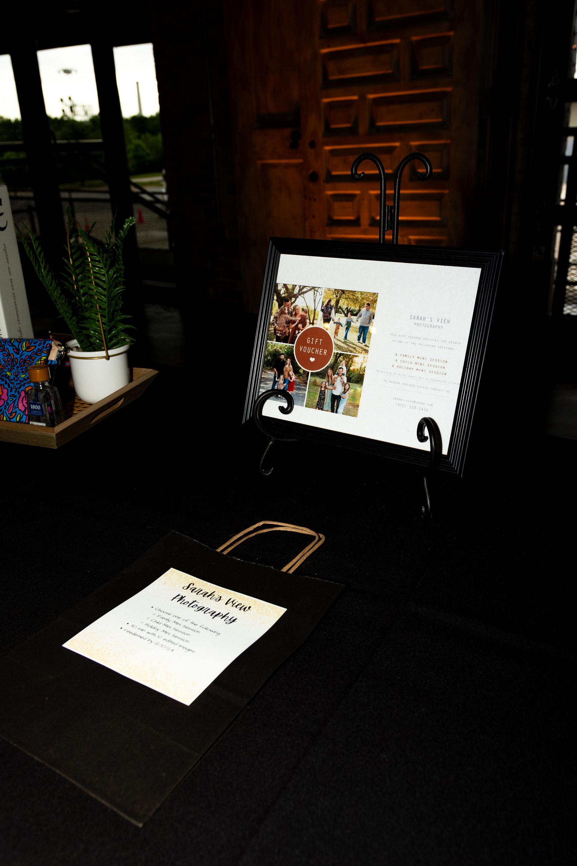 Restaurant menu on stand, another on table, in a dark, cozy setting.