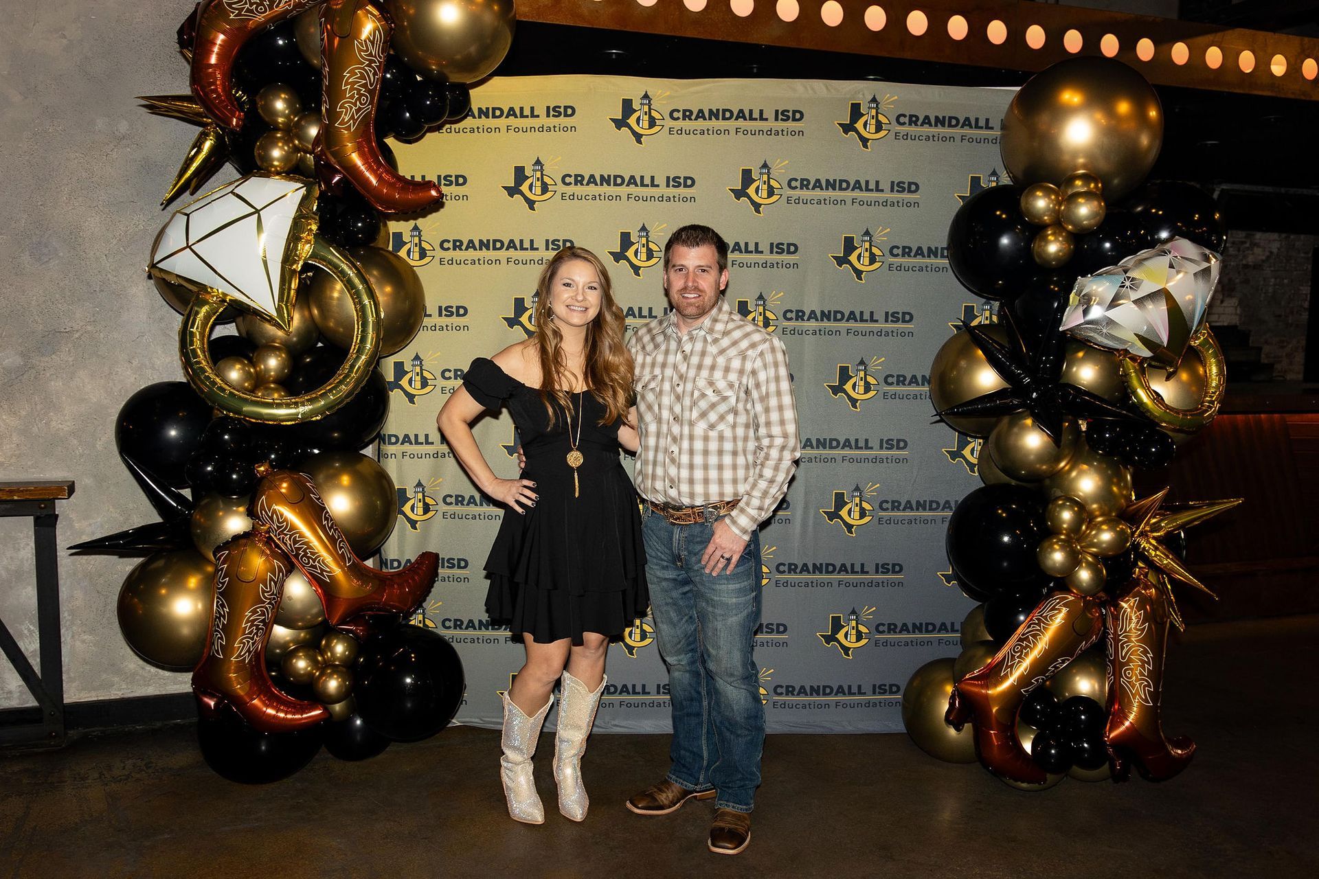 Couple poses in front of a 