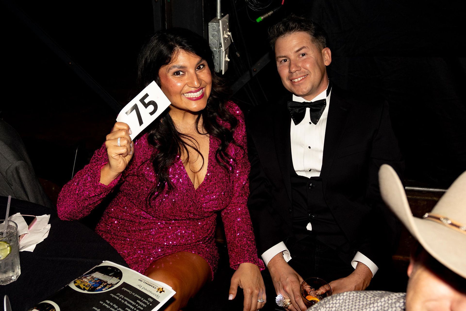 Woman in sparkly pink dress holds 