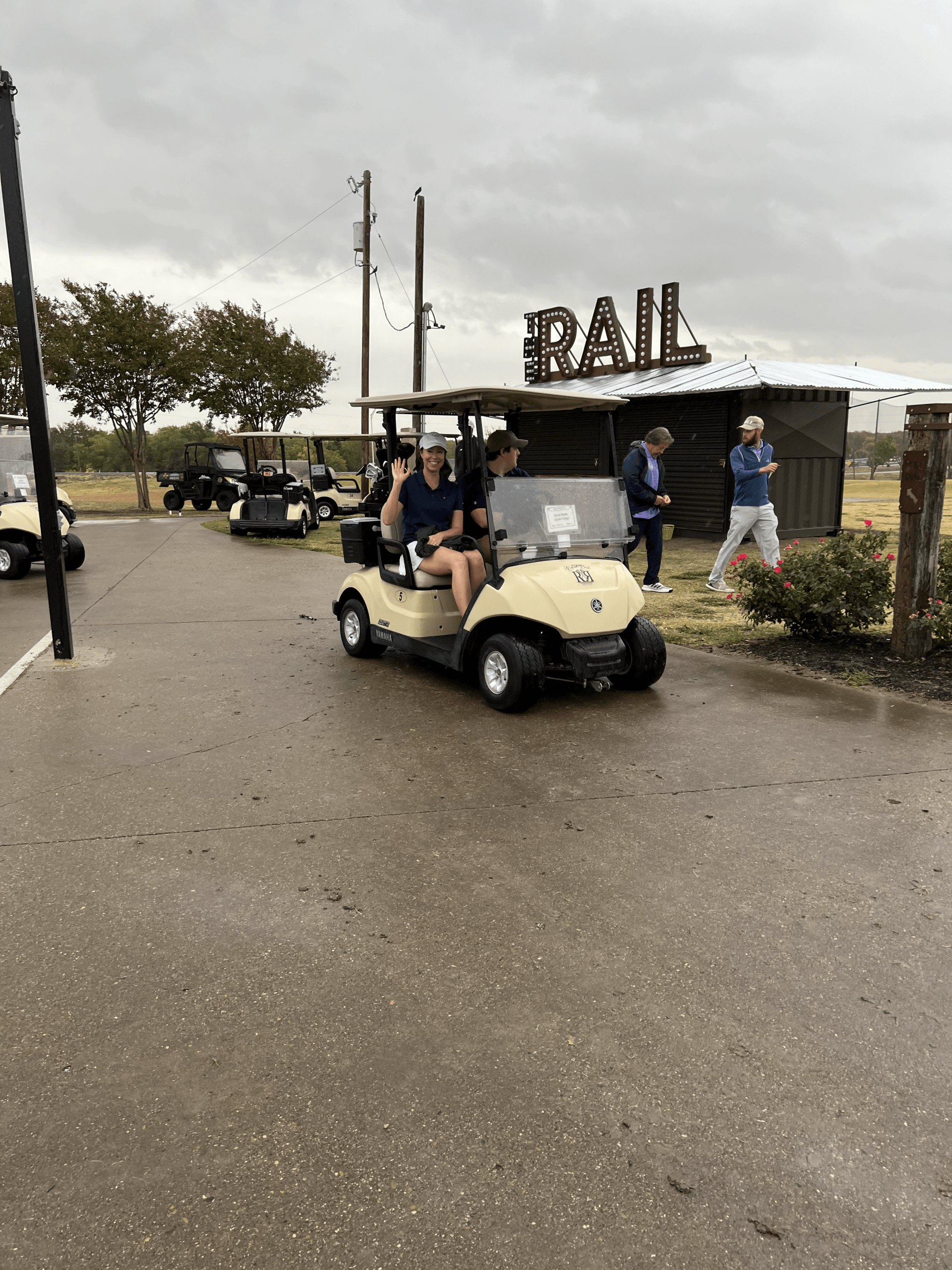 Golf cart with people, driving past 