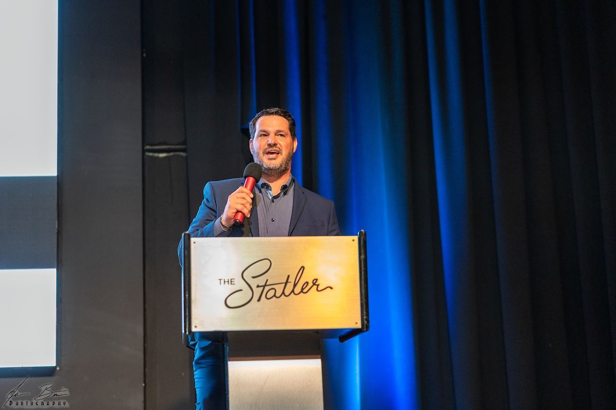 Man speaking at a podium with 