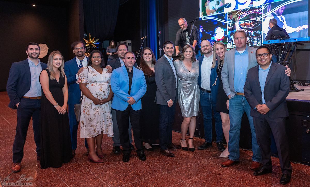 Group photo of people, many smiling at a formal event.