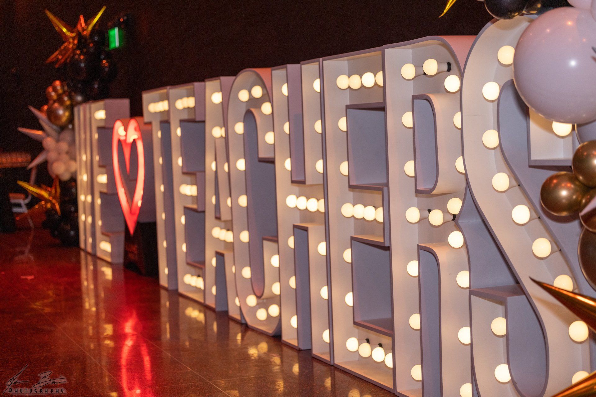 Large, glowing marquee letters spell 
