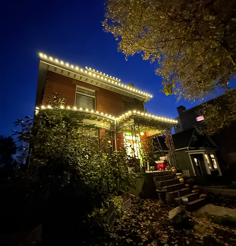 A house is lit up with christmas lights at night