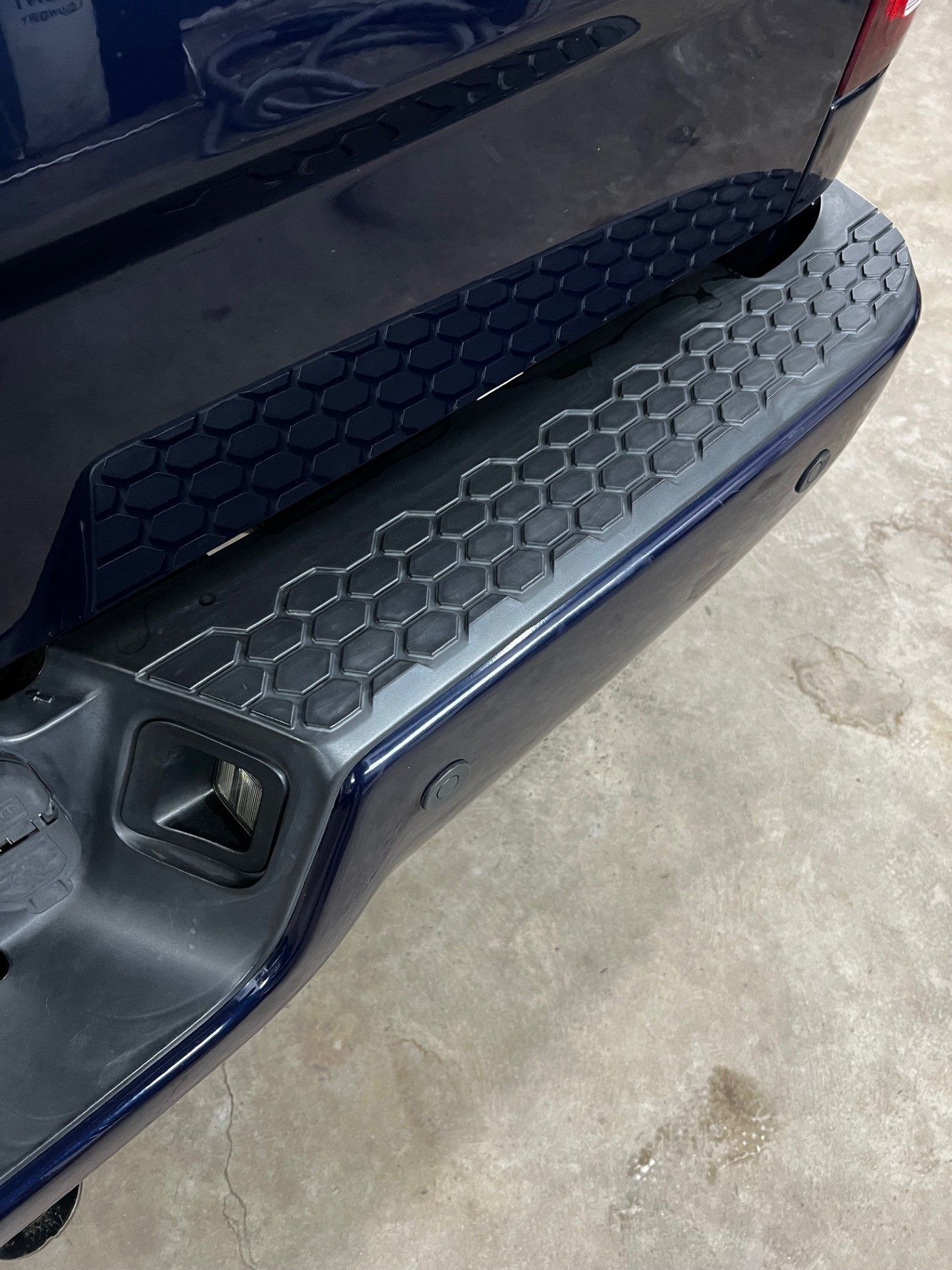 Faded black plastic trim before and after restoration on a vehicle in Westminster Maryland