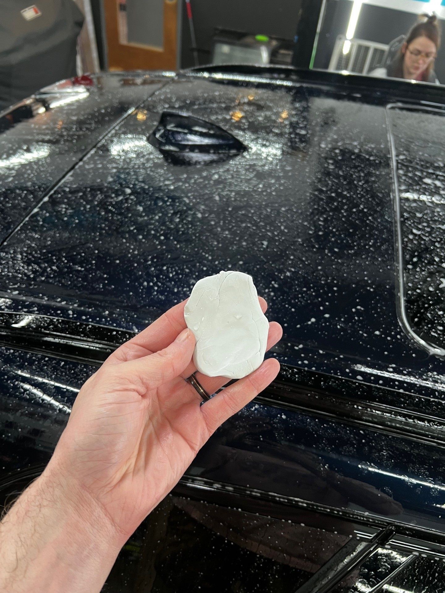 Close-up of vehicle paint with visible contamination before clay barring treatment in Westminster, MD