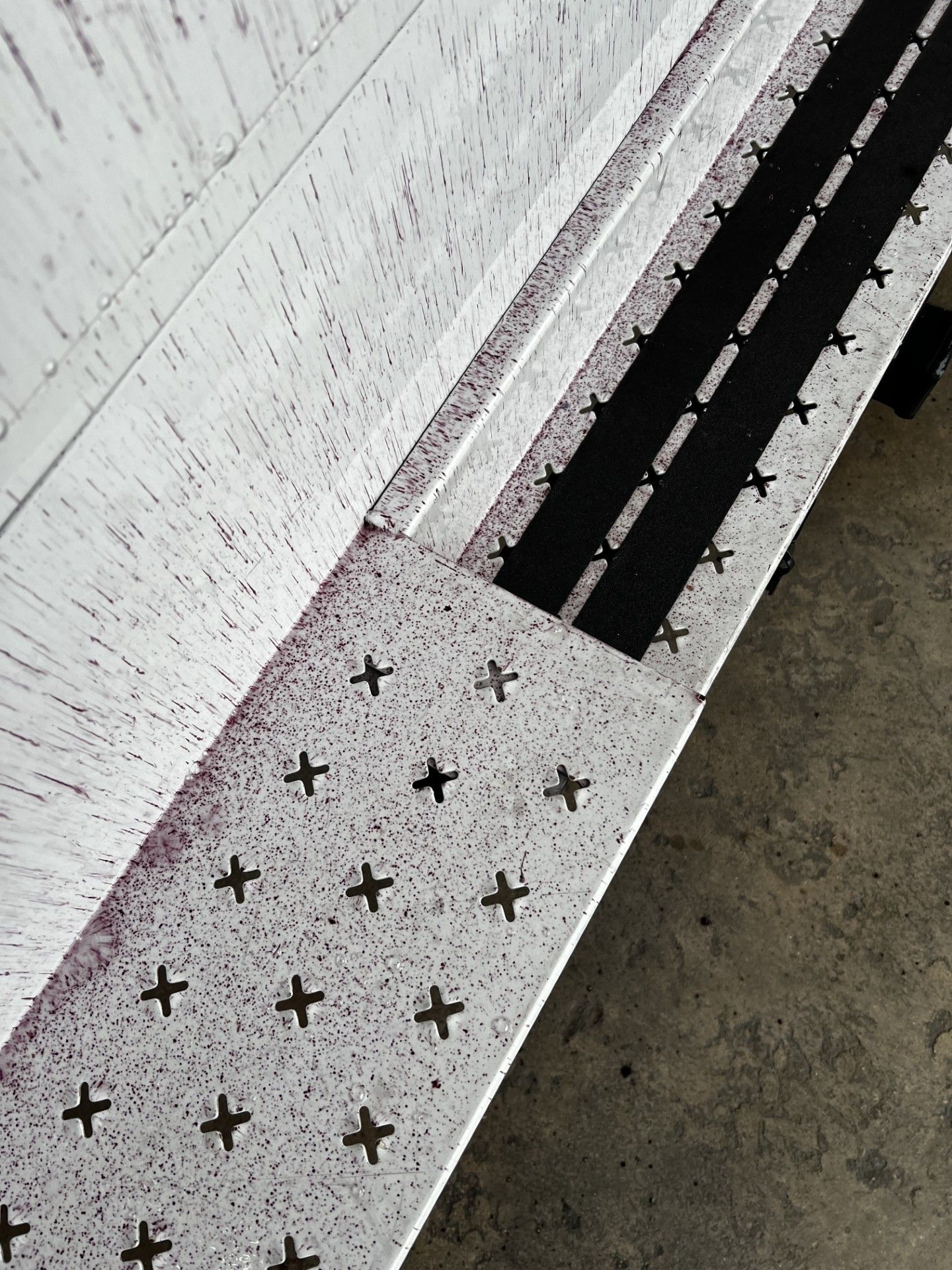 Orange rust-like rail dust contamination embedded in vehicle paint