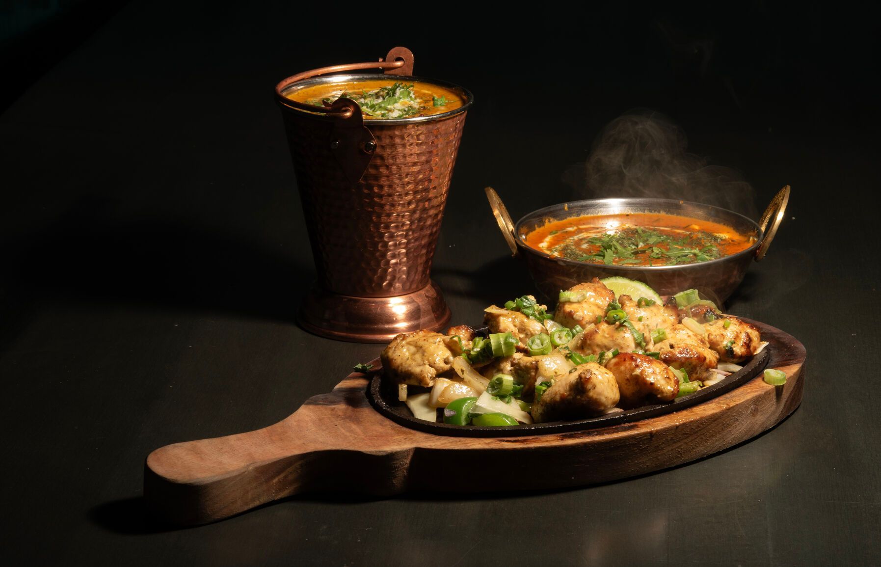 A table topped with bowls of food and the words `` now open ''.