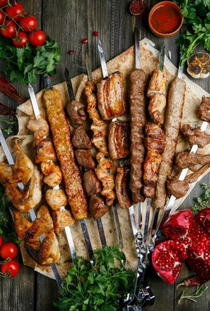 A tray of food with bread , rice , and sauces on a table.