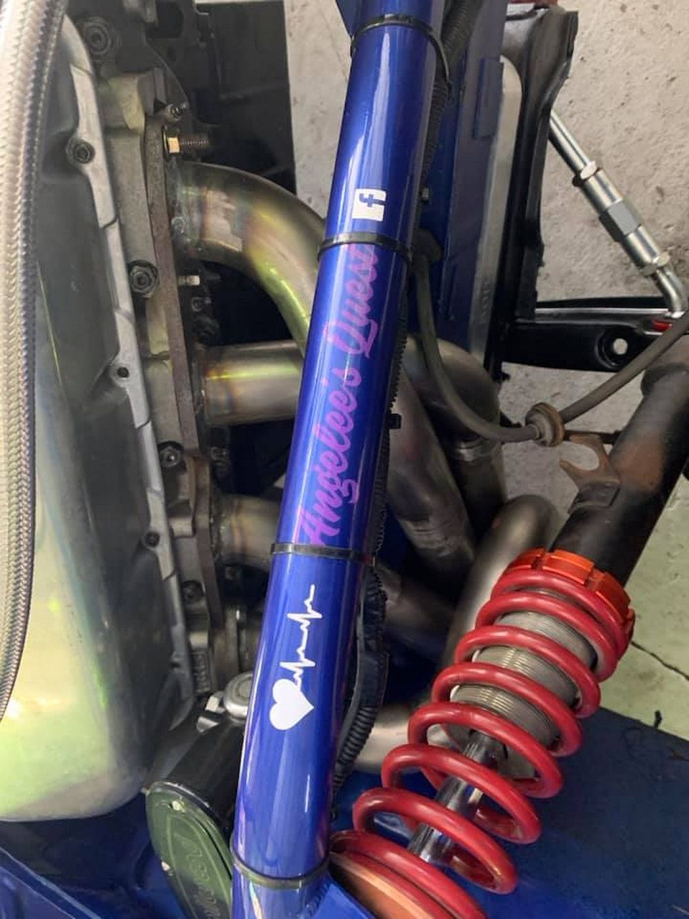 A Close Up Of A Blue Car With A Red Shock Absorber — Hannam Street Mufflers and Mechanical In Bungalow, QLD