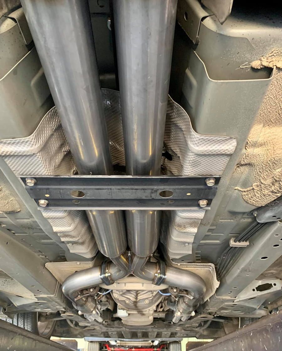 A Close Up Of The Underside Of A Car With Exhaust Pipes — Hannam Street Mufflers and Mechanical In Bungalow, QLD