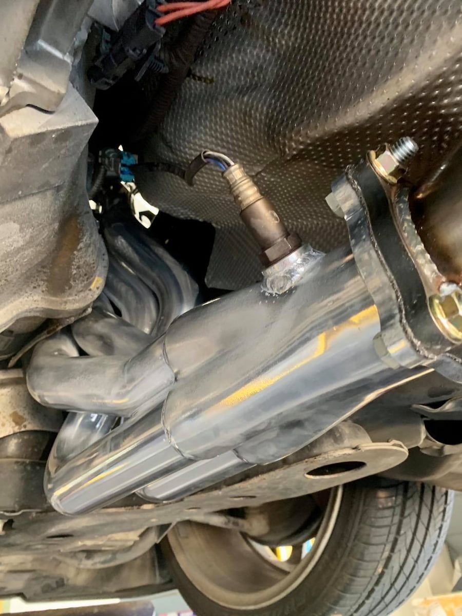 A Close Up Of The Underside Of A Car With A Exhaust Pipe — Hannam Street Mufflers and Mechanical In Bungalow, QLD