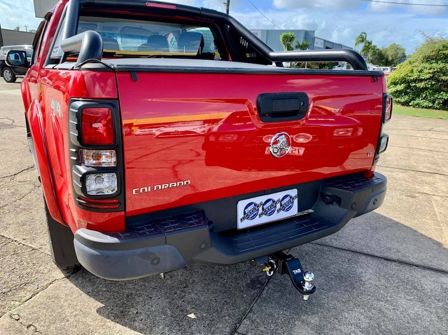 A Red Pickup Truck Is Parked On The Side Of The Road — Hannam Street Mufflers and Mechanical In Bungalow, QLD