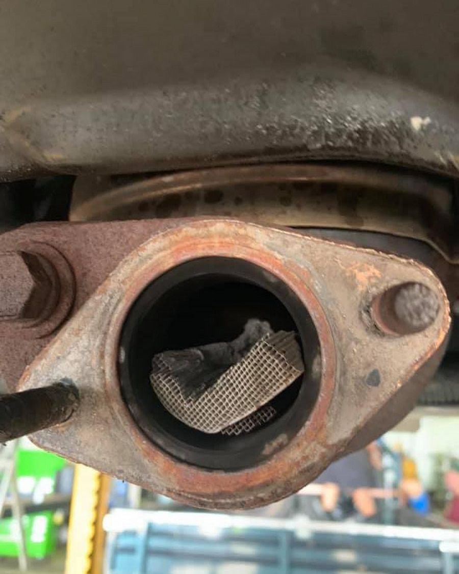 A Close Up Of A Car Exhaust Pipe With A Hole In It — Hannam Street Mufflers and Mechanical In Bungalow, QLD