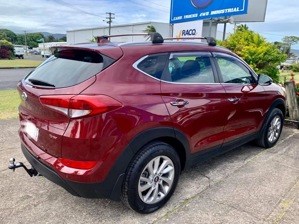 A Red Hyundai Tucson Is Parked On The Side Of The Road — Hannam Street Mufflers and Mechanical In Bungalow, QLD