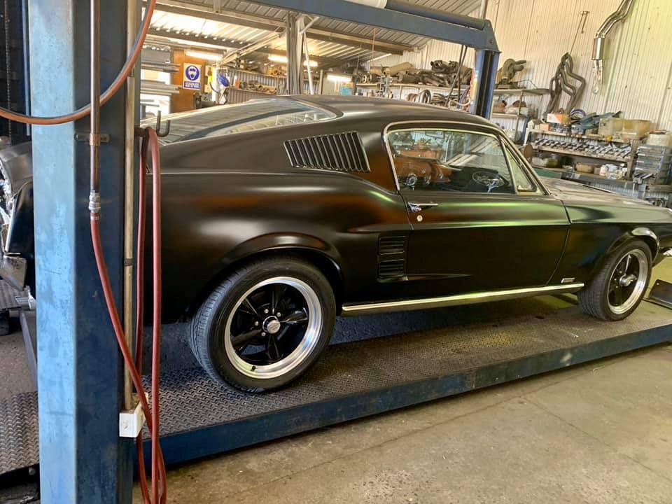 A Black Mustang Is Parked In A Garage On A Lift β Hannam Street Mufflers and Mechanical In Bungalow, QLD