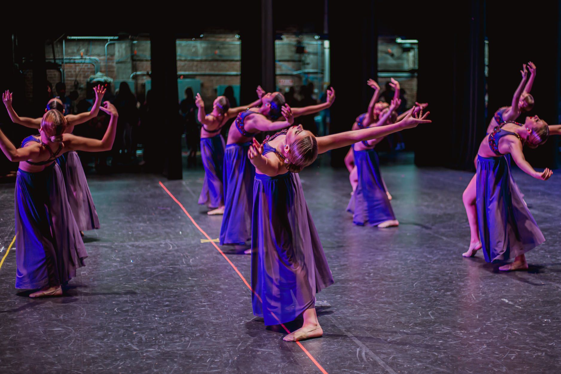A group of dancers are dancing on a stage.