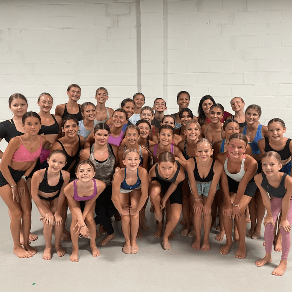 A large group of young women are posing for a picture.
