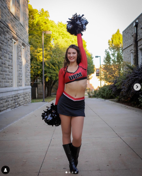 A cheerleader wearing a red top with ucsd on it