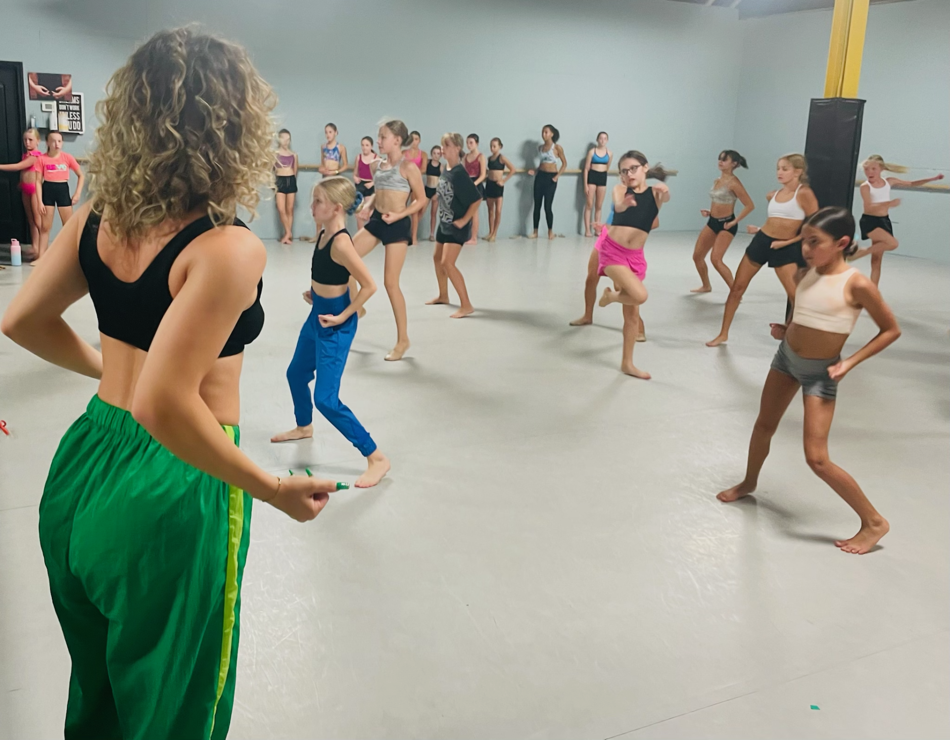 A group of women are dancing in a dance studio