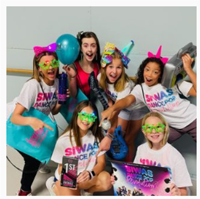 A group of girls wearing shirts that say swas dance pop