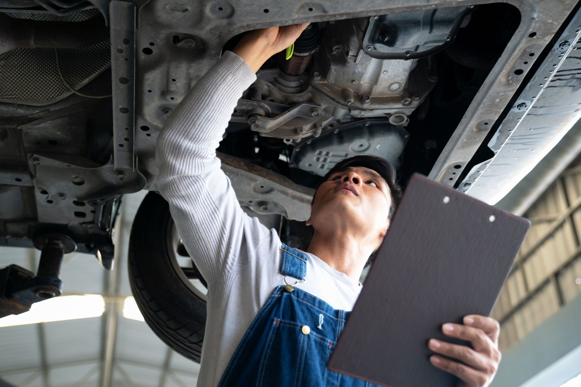 Mechanic Checking Under Floor Car – Burlingame, CA – Tony’s Auto Repair