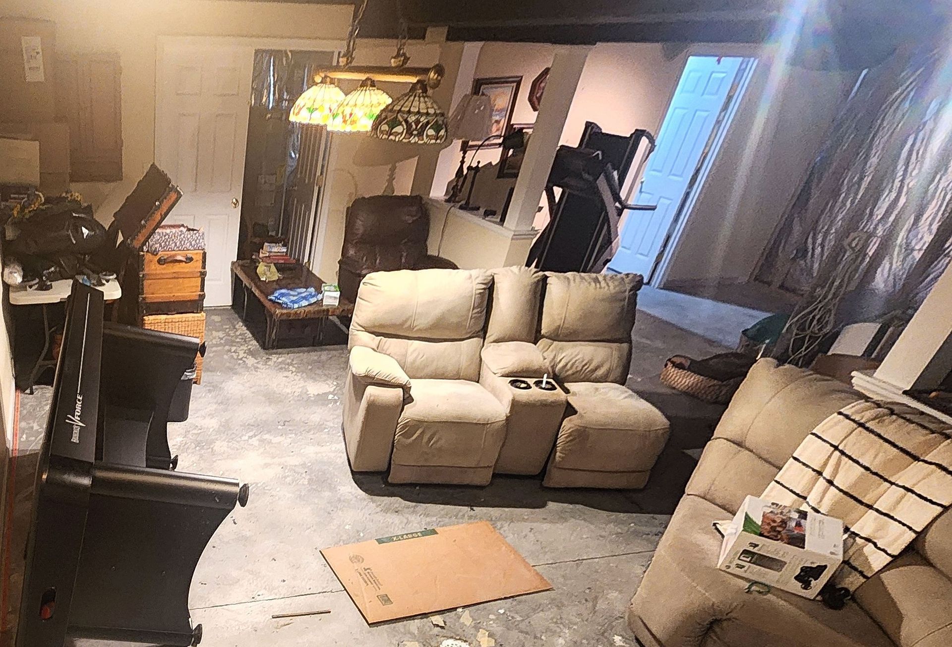 A living room with a couch , chairs , and a piano.