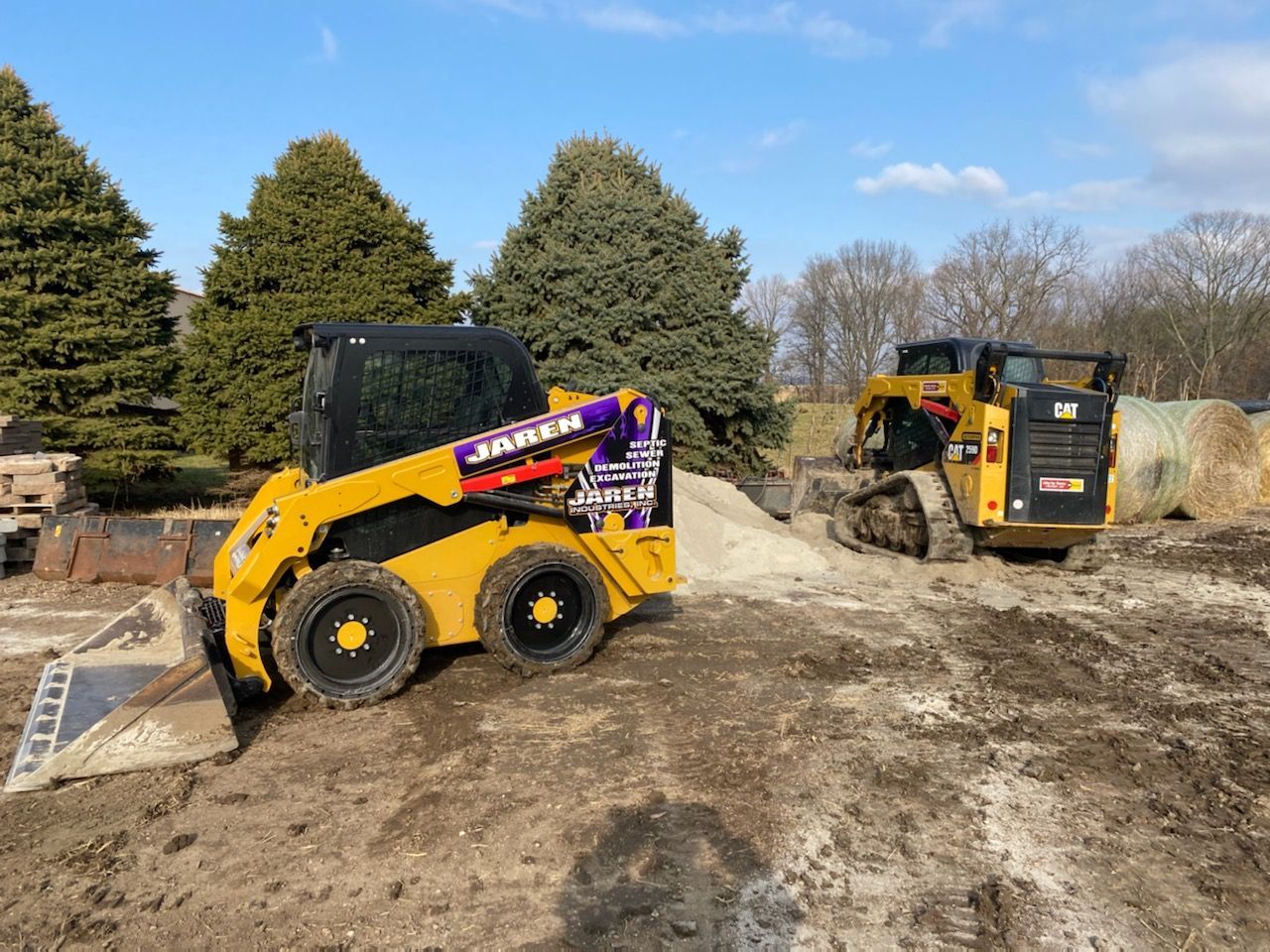 Two yellow excavation truckYellow tractor preparing for land clearing - Springfield, IL - Jaren Industries