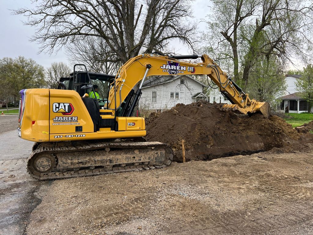 Yellow tractor Preparing soil - Springfield, IL - Jaren Industries