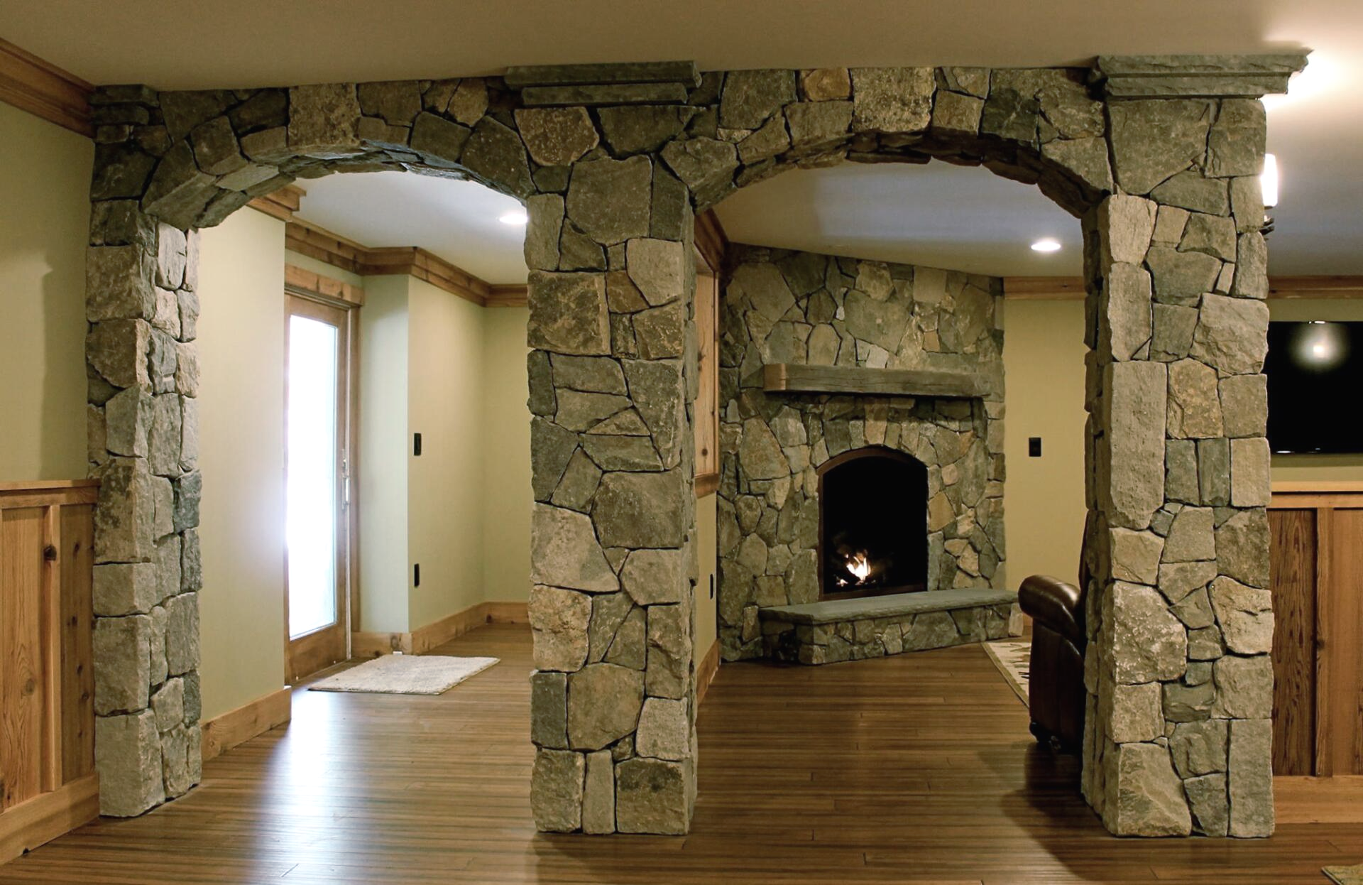 Stone archways leading to a fireplace