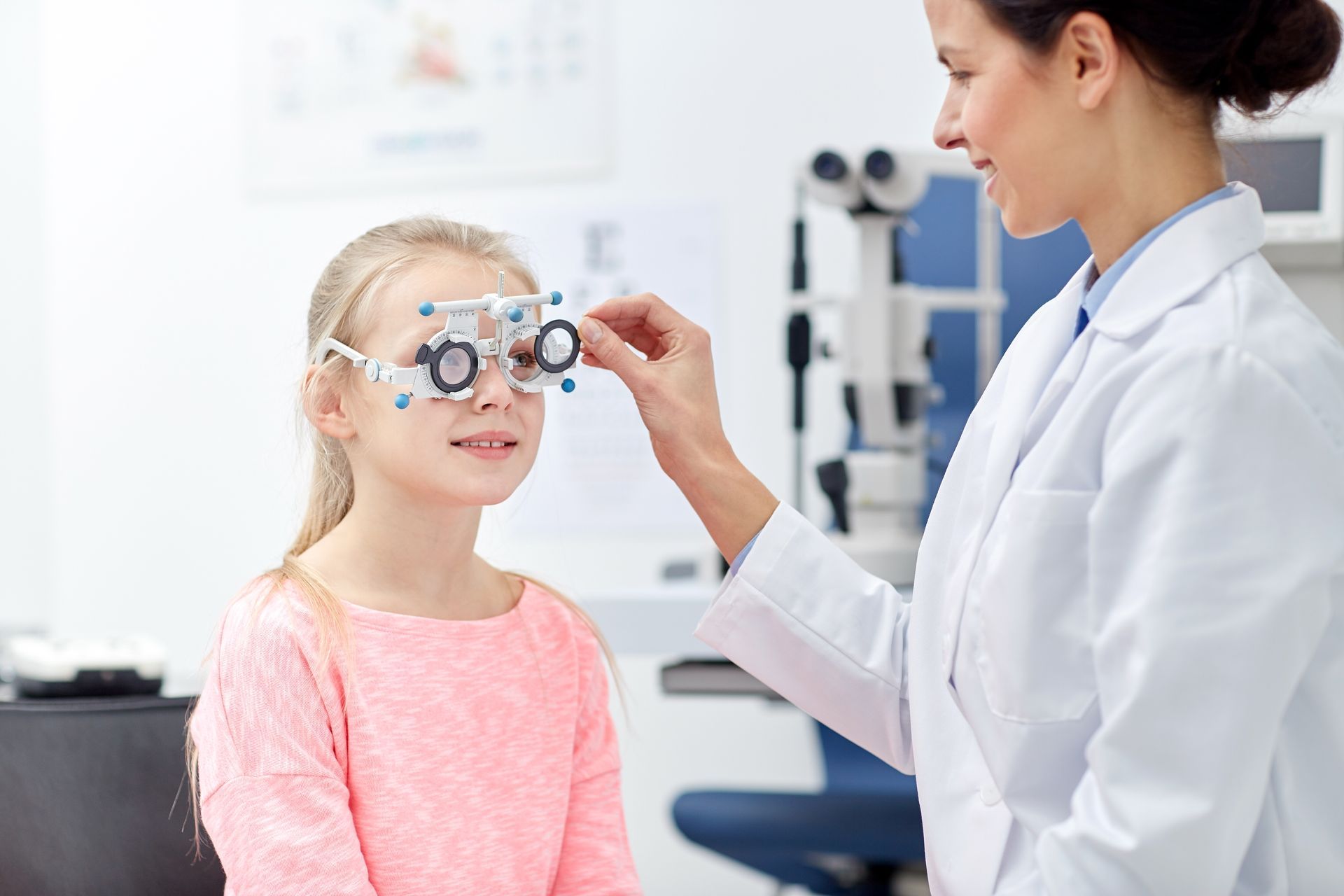 optometrist checking in on little girl's eyes