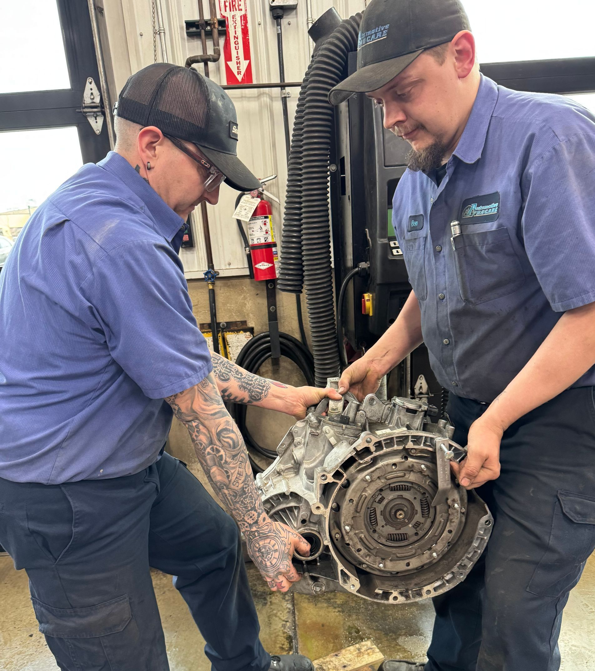 A man is working on the engine of a car.