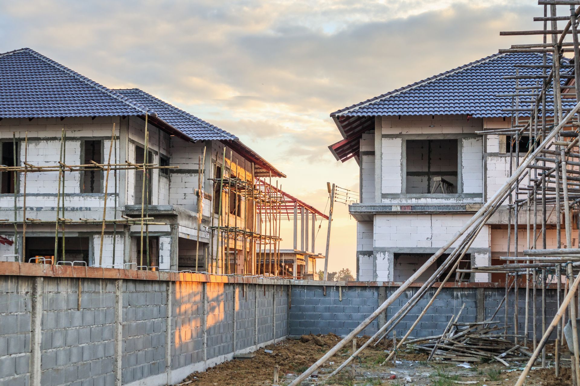 Two houses are being built in a residential area.