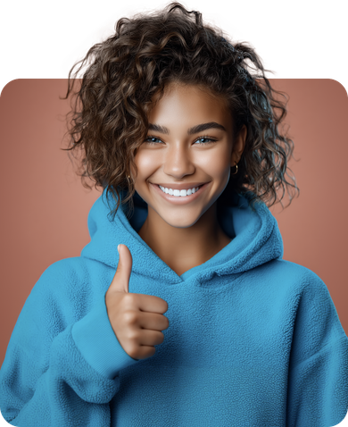 Young woman with curly hair smiles, giving a thumbs-up, wearing a blue hoodie.