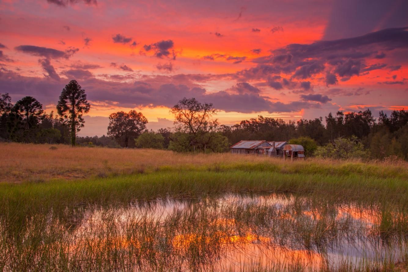 A Sunset Over a Swamp with A House in The Distance — Podium Solar in Singleton, NSW