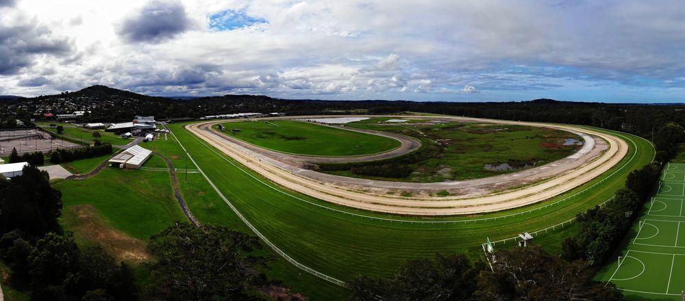 An Aerial View of A Horse Race Track with A Soccer Field in The Foreground — Podium Solar in Wyong, NSW