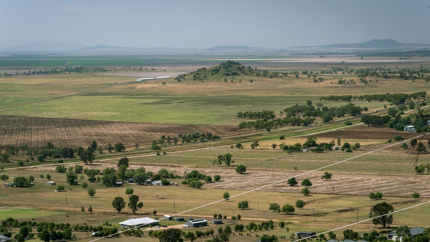 An Aerial View of A Lush Green Field with Trees and Houses — Podium Solar in Gunnedah, NSW