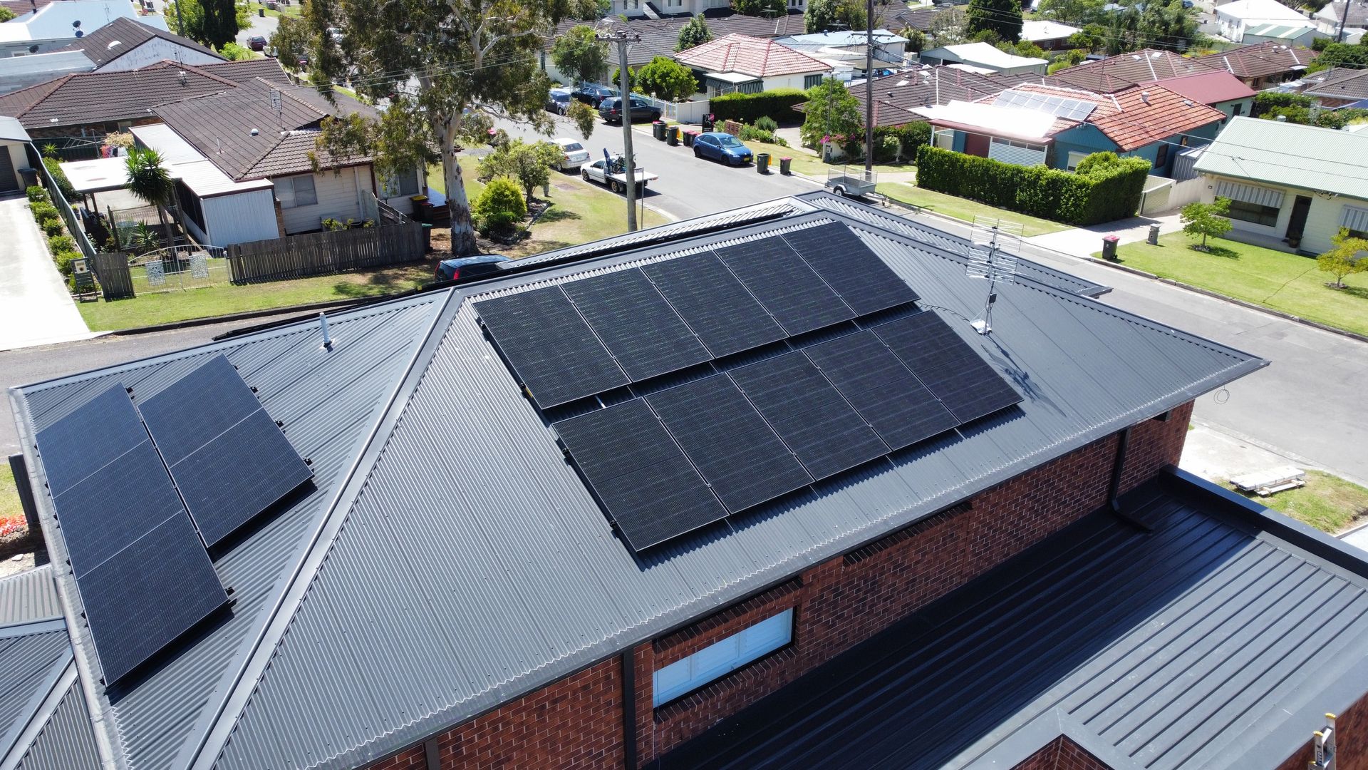A Field of Solar Panels with The Sun Shining Through Them — Podium Solar in Port Macquarie, NSW
