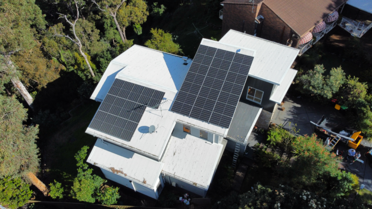 An Aerial View of A House with Solar Panels on The Roof — Podium Solar in Toronto, NSW