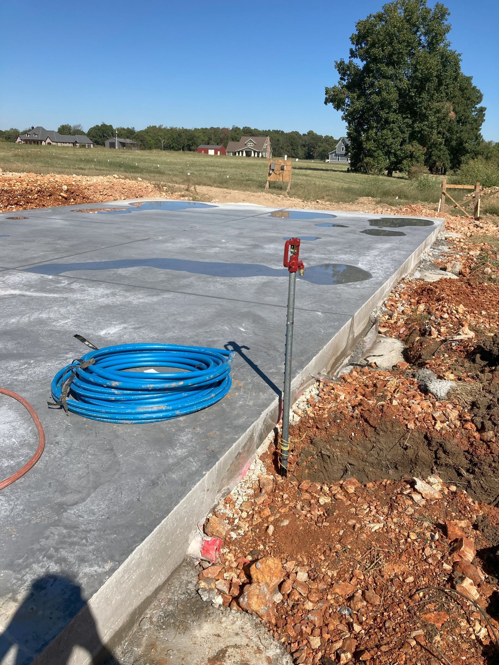 A hose is laying on the ground in a construction site