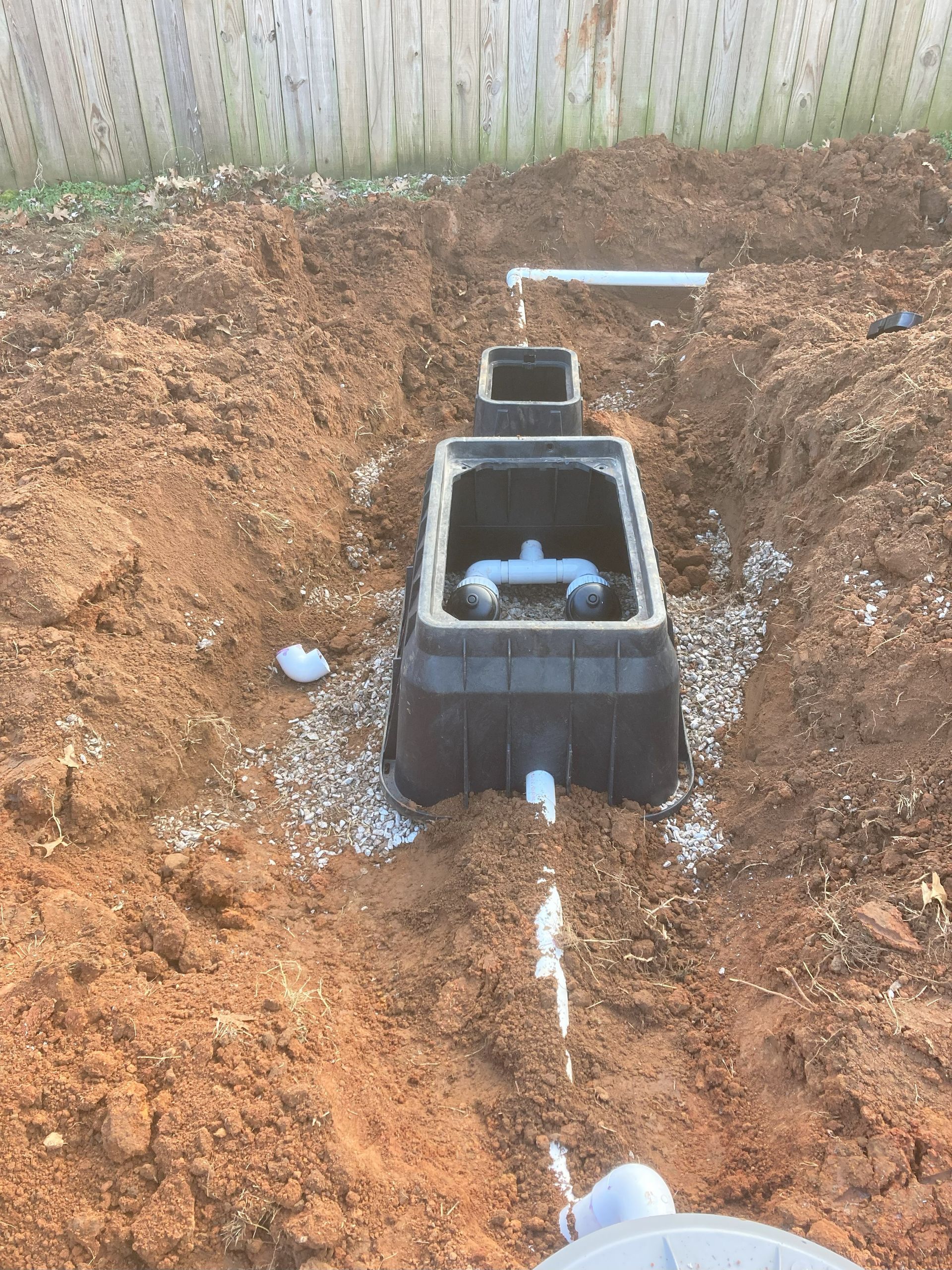 A black box is sitting in the middle of a dirt field.